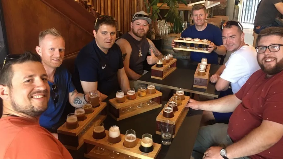 Group of men enjoying a craft beer tasting session in Wellington