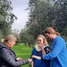 Guests sampling olives during a guided olive grove tour in Martinborough