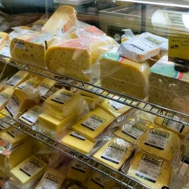 Close-up of artisan cheeses in a deli fridge on a Martinborough Foodie Tour
