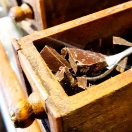 Close-up of dark chocolate chunks in a wooden drawer during a blind tasting in Martinborough