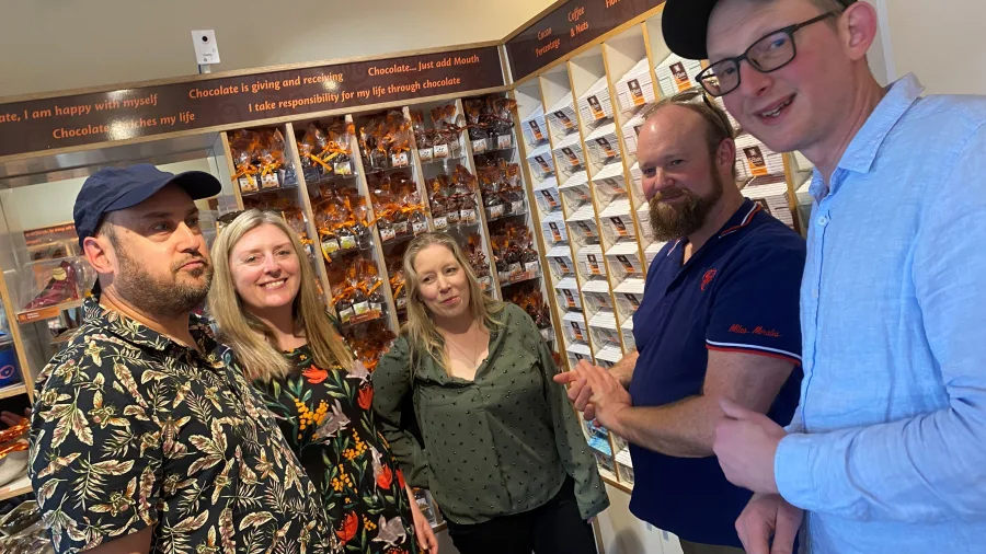 Group of guests sampling artisan chocolates inside a Martinborough chocolate shop