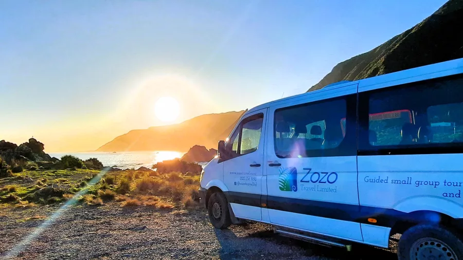 Zozo Travel tour van parked by the Wairarapa coast at sunset