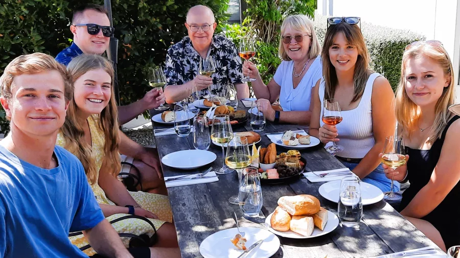 Group enjoying an outdoor wine and food lunch at a vineyard in Martinborough