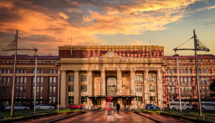Wellington Railway Station at sunrise with golden light reflecting on the building facade