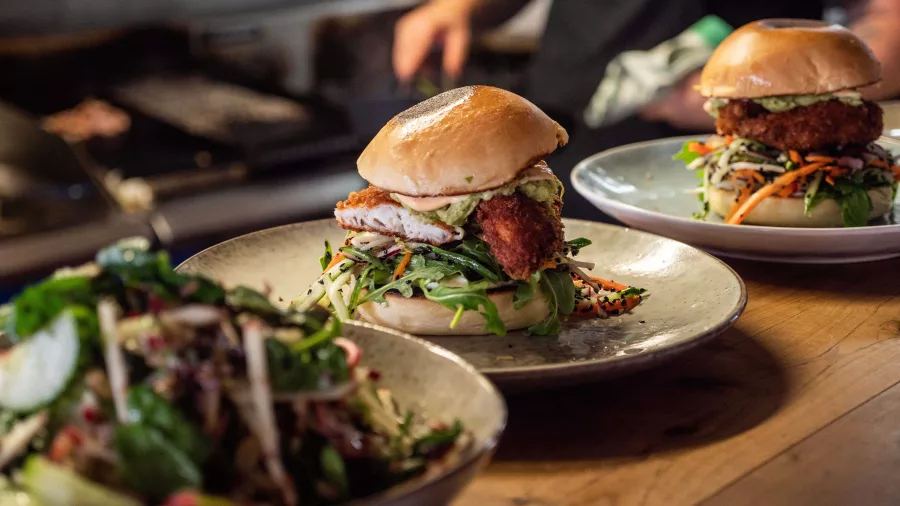 Close-up of gourmet burgers served at Raumati Social Club on the Kapiti Coast