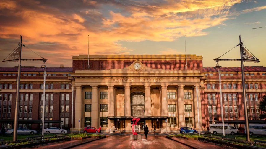 Wellington Railway Station at sunrise with golden light reflecting on the building facade