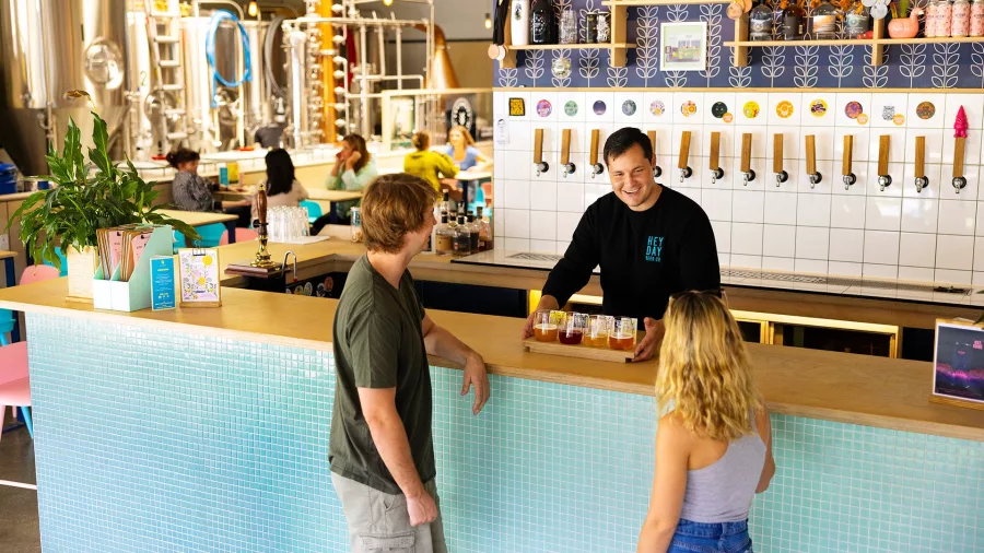 Couple receiving a flight of craft beers at Heyday Beer Co brewery in Wellington