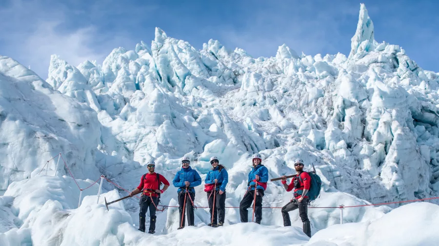 Group ice climbing during a glacier helihike on Fox Glacier near Franz Josef on the West Coast