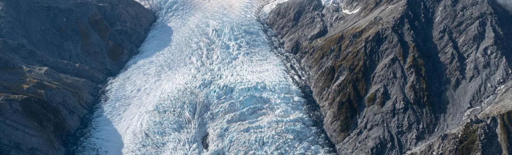 Aerial view of Franz Josef Glacier framed by rugged mountains