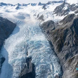 Aerial view of Franz Josef Glacier framed by rugged mountains