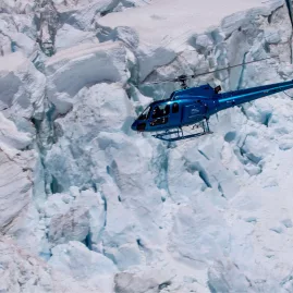 Glacier Country Helicopters flying above the icy terrain of Franz Josef Glacier