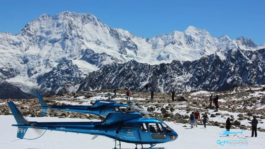 Glacier Country Helicopters snow landing at Liebig Dome with passengers and Southern Alps backdrop