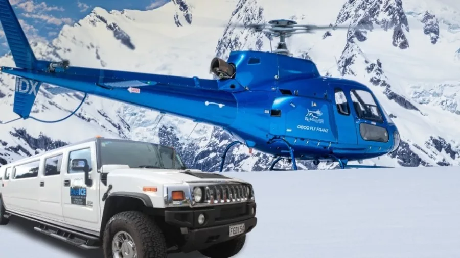 Blue helicopter and white Hummer limousine on snow at Glacier Country Helicopters Franz Josef