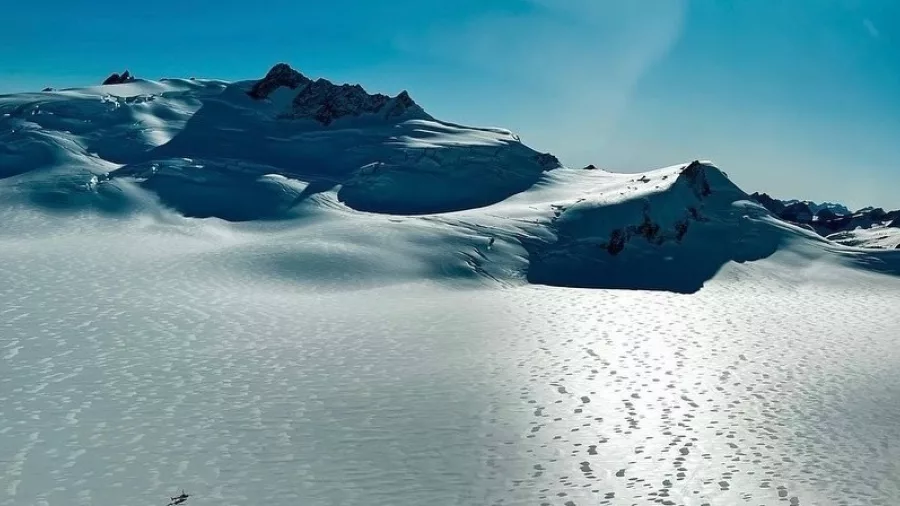 Aerial view of a snow-covered glacier plateau between Wanaka and Franz Josef in New Zealand