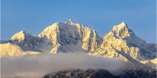Snow-covered peaks of the Southern Alps in New Zealand at sunrise