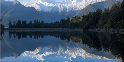 Reflections of snow-capped Mount Cook and Mount Tasman on Lake Matheson