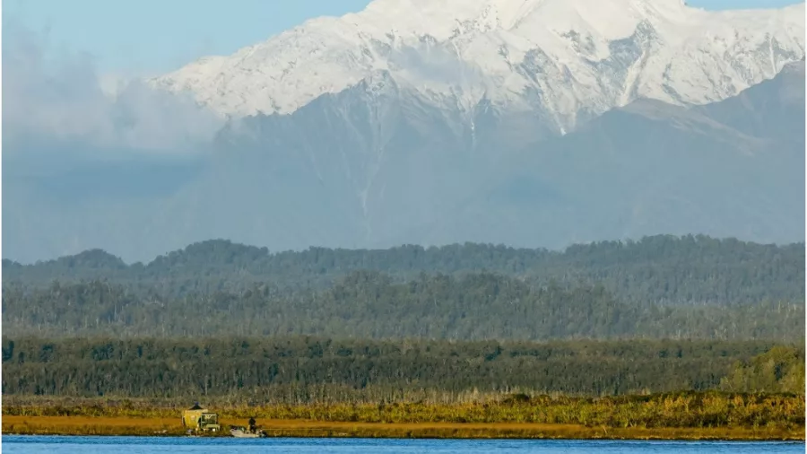 Okarito Lagoon with a scenic view of the Southern Alps in the background