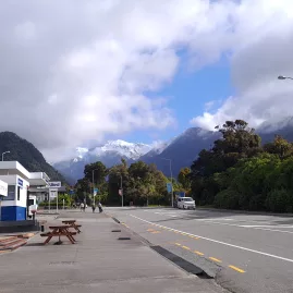 Franz Josef village main street with views of the Southern Alps on the West Coast