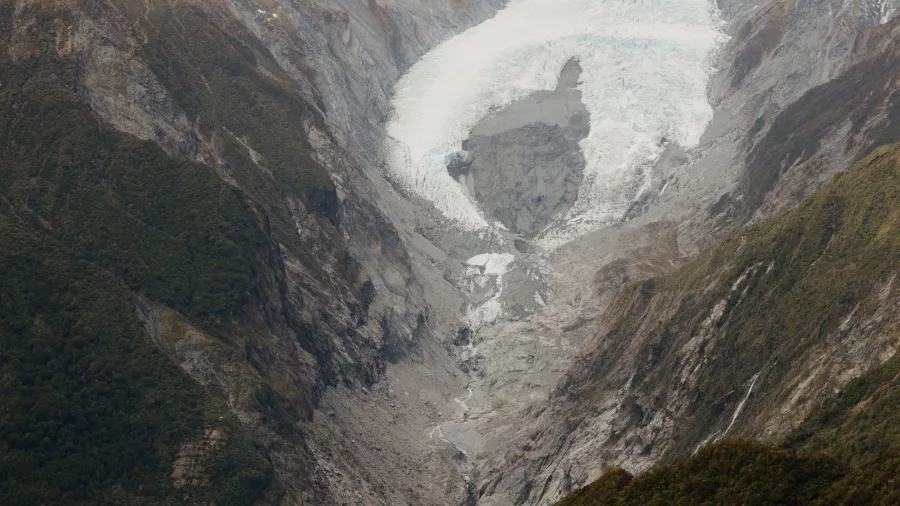 Hiker looking out over Franz Josef Glacier from Alex Knob Track on the West Coast