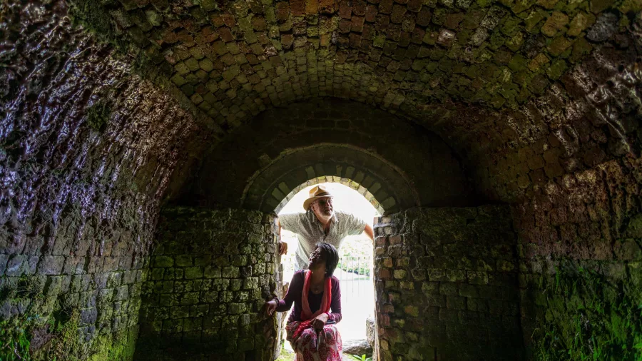Visitors exploring the historic brick kiln tunnel at Brunner Mine Site in Greymouth