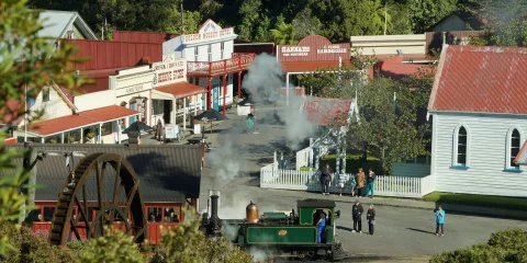 View of the heritage village and steam train at Shantytown Heritage Park near Greymouth on the West Coast of New Zealand.
