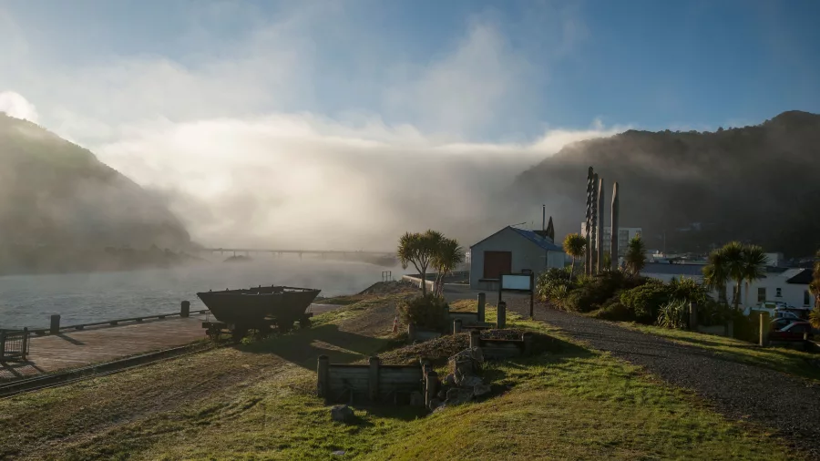 Historic site in Greymouth on a misty morning with old mining cart and buildings on the West Coast of New Zealand