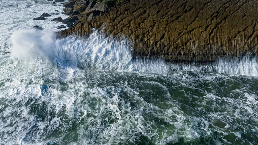 Waves crashing against the rugged cliffs at Scotts Beach on the West Coast near Karamea