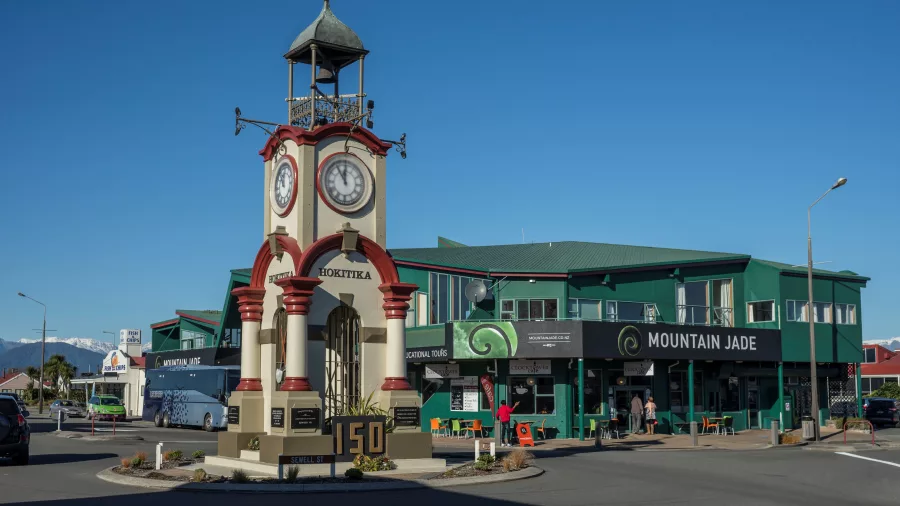 Hokitika Clock Tower and Mountain Jade building under a clear blue sky