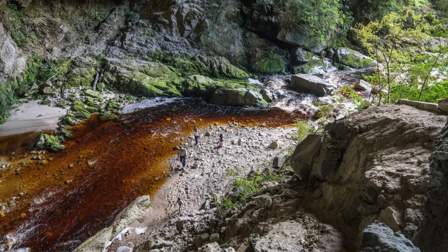 Family exploring the riverbed near Ōpārara Arches in Kahurangi National Park, Karamea