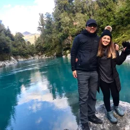 Couple posing by the turquoise waters of Hokitika Gorge, West Coast New Zealand