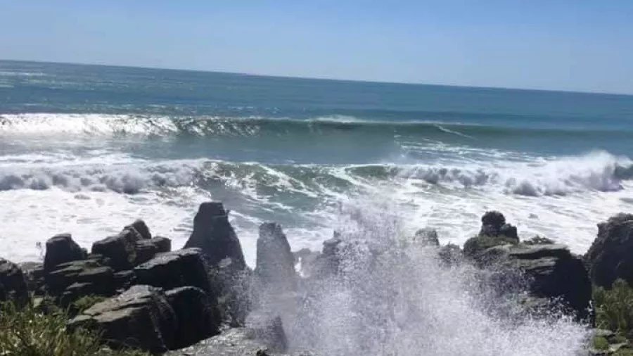 Blowhole in action at Punakaiki on the West Coast, with ocean spray shooting into the air