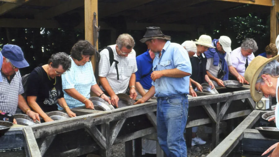 Group of visitors learning to pan for gold at Shantytown Heritage Park