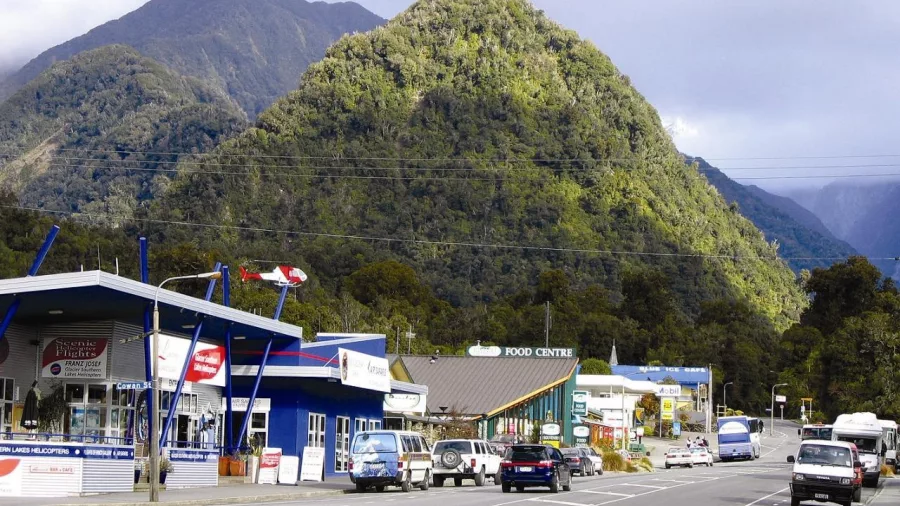 Scenic view of Franz Josef township with lush West Coast hills in the background