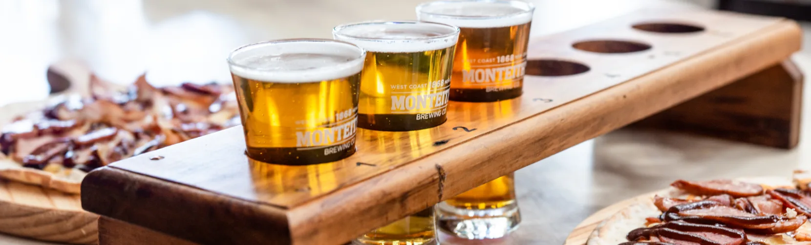 Beer tasting tray and pizzas at Monteith’s Brewery in Greymouth