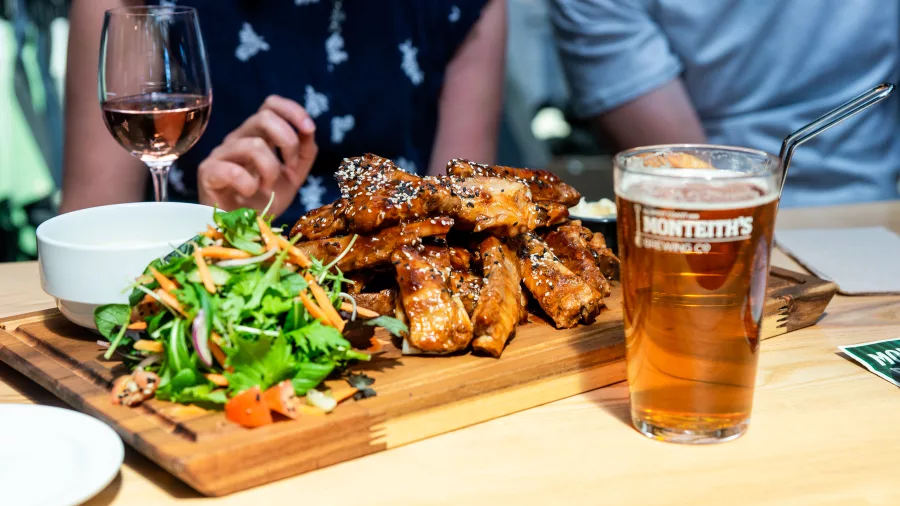 Monteith’s Brewery meal with ribs, salad, and a glass of beer