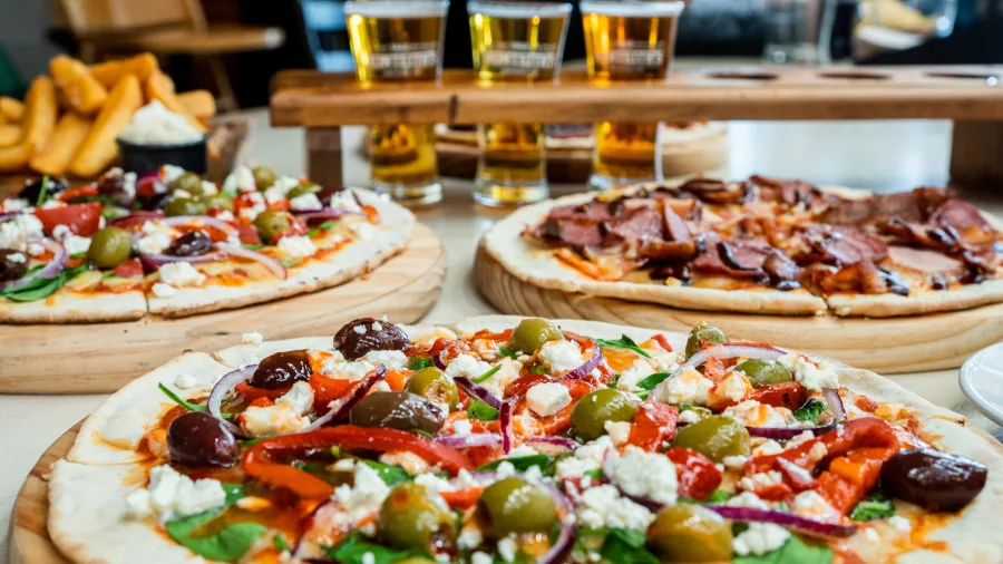 Selection of gourmet pizzas with beer tasting tray at Monteith’s Brewery