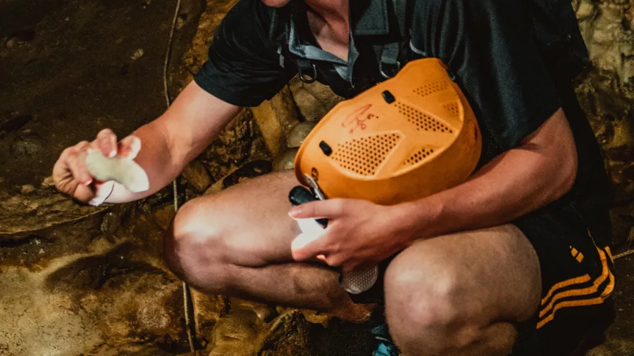 Underworld Adventures cave guide demonstrating cave features during the Glow Worm Cave Tour in Charleston, New Zealand