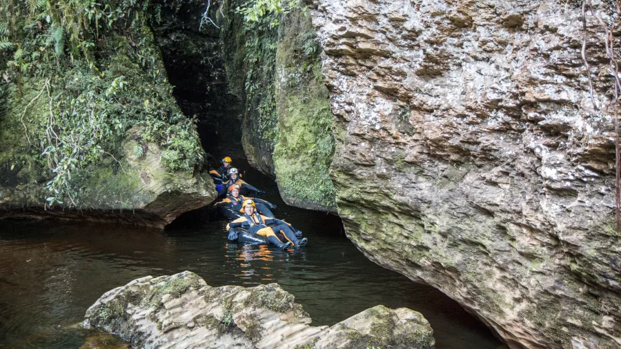 Guided tubing tour emerging from a cave at Underworld Adventures Charleston