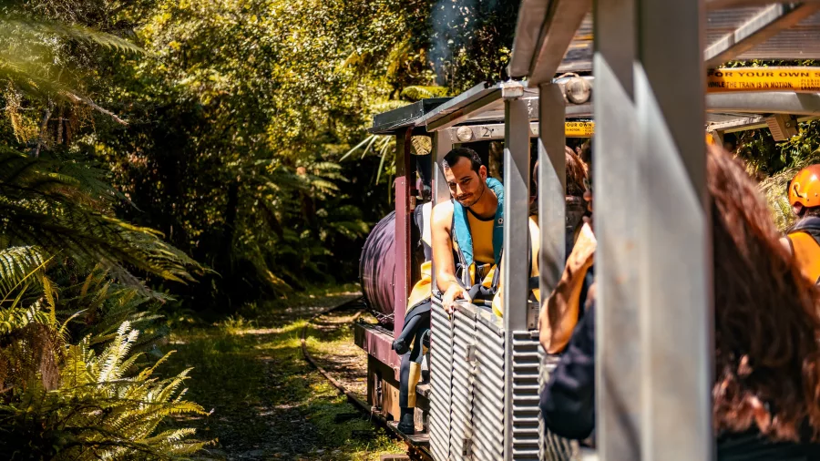 Visitors on the open-air rainforest train to Underworld Adventures cave tour in Charleston