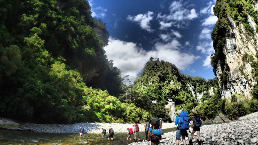 Group of hikers approaching the Ballroom Overhang in Paparoa National Park