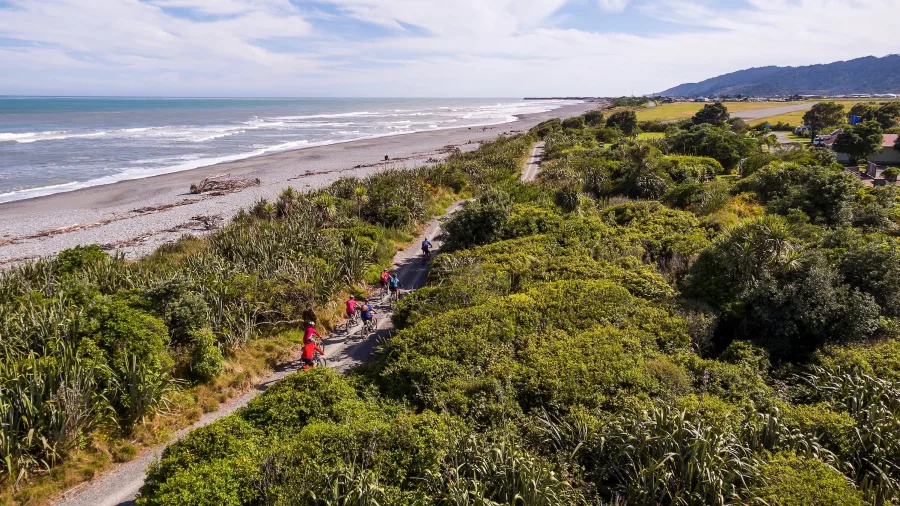 Cyclists riding along the West Coast Wilderness Trail near the Greymouth coastline