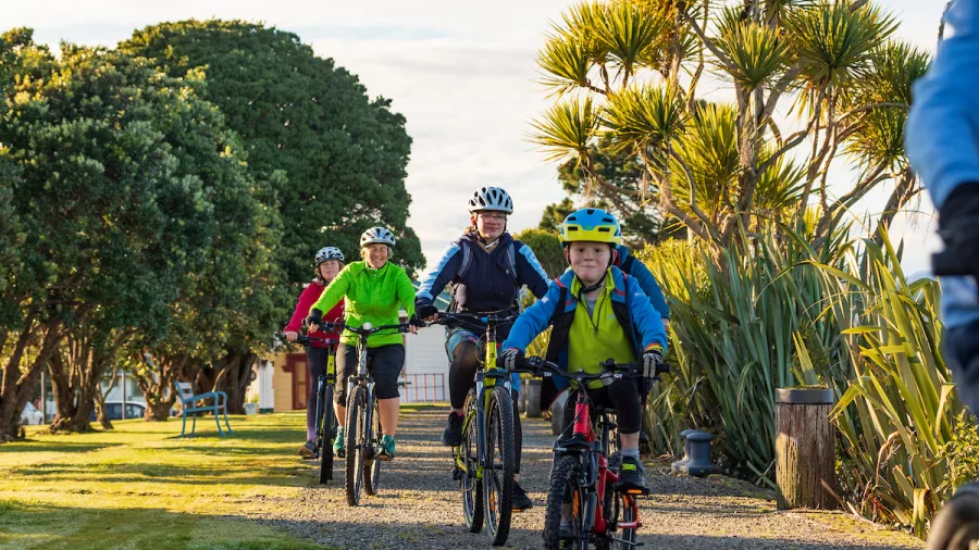 Family cycling Gibson Quay section of the West Coast Wilderness Trail in Hokitika