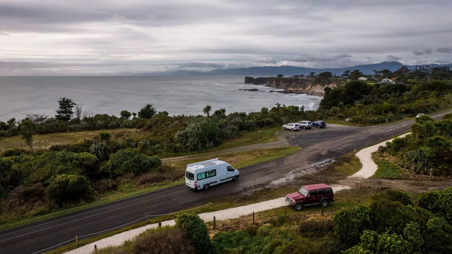Campervan driving along the Westport coastline on New Zealand’s West Coast
