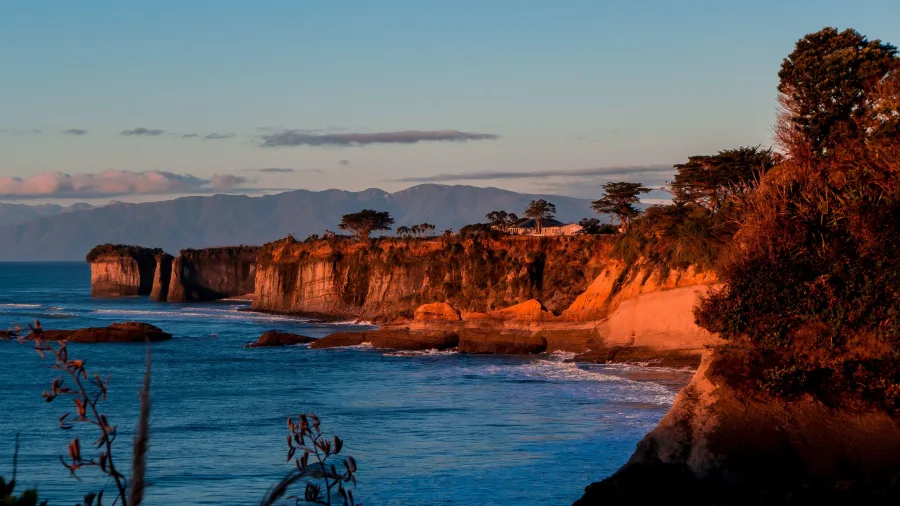 Sunlight casting a warm glow on the cliffs at Cape Foulwind near Westport on New Zealand’s West Coast