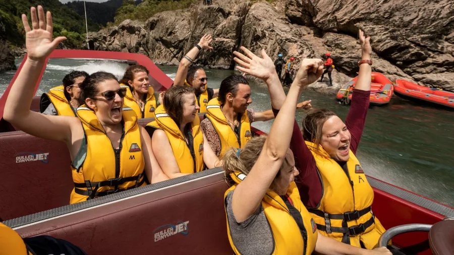 Excited passengers on a Buller Gorge Canyon Jet ride near Westport on New Zealand’s West Coast