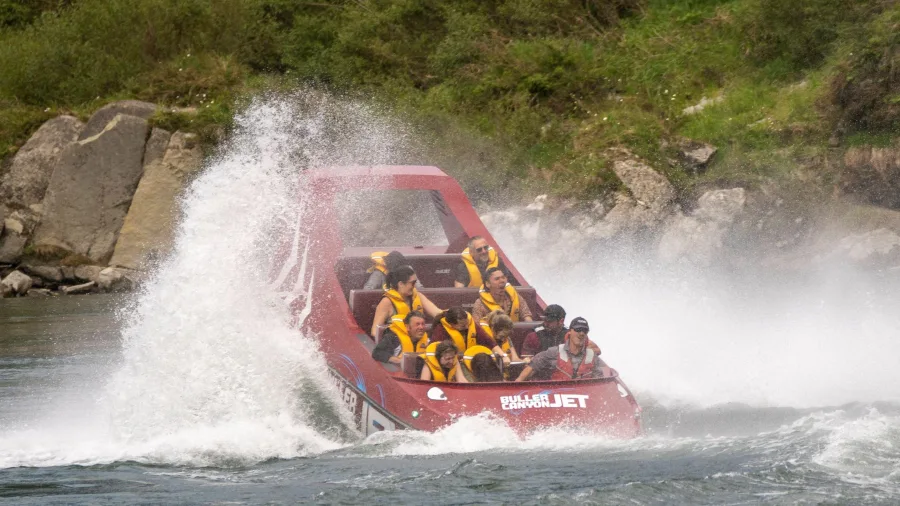 Buller Gorge Canyon Jet boat splashing through the water near Westport on New Zealand’s West Coast